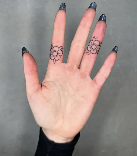Cherry blossom finger tattoos by Luke Ashley at Aura ninety four in London