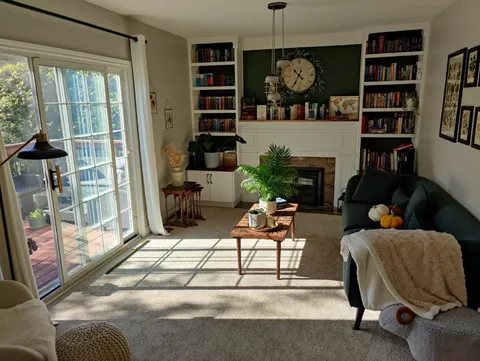 Our living room in the morning. Books, coffee and cheeky dog.