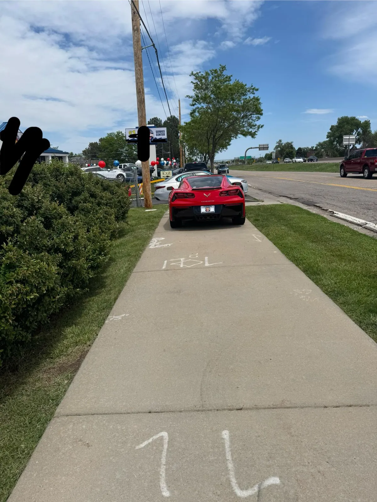 Car dealership blocking the sidewalk with their cars