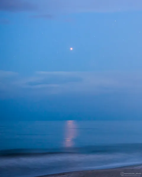Mars casts a warm reflection on the surface of the ocean during an opposition in which the red planet was closest to Earth since 2003.