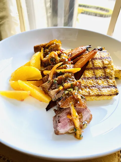 Duck a l’orange with grilled polenta and roasted baby carrots