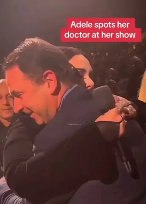 Adele spots the doctor who delivered her baby.