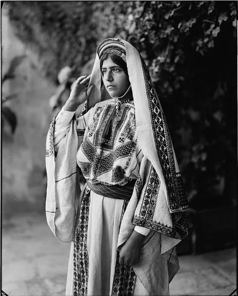 Palestinian girl from the city of Ramallah, on her traditional clothes, very crisp and sharp glass negative, 1898.