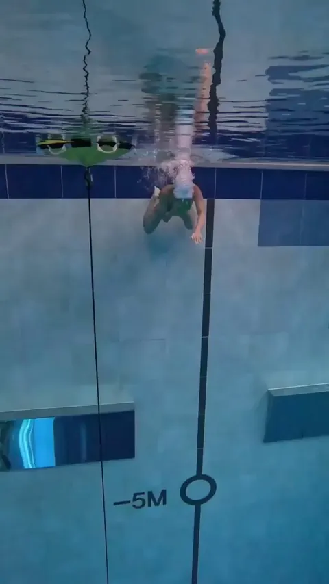 Girl dive in the diving pool