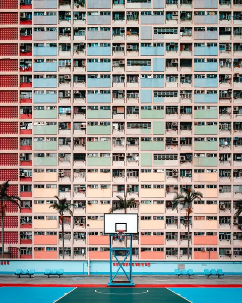 ITAP of a basketball hoop in front of a colourful apartment block