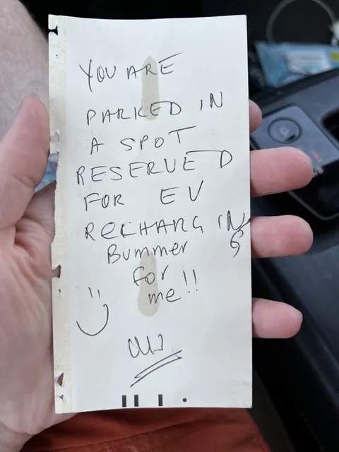 Note left on my car (an EV) while parked at a clearly broken and disconnected charger
