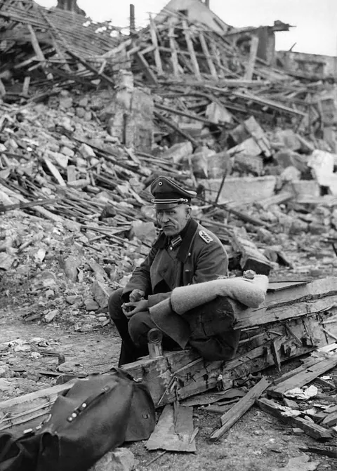After the fall of the city without a fight, a German officer awaiting his fate in the ruins, eating rations from the US Army on March 22, (1945) in Saarbrucken, Germany.