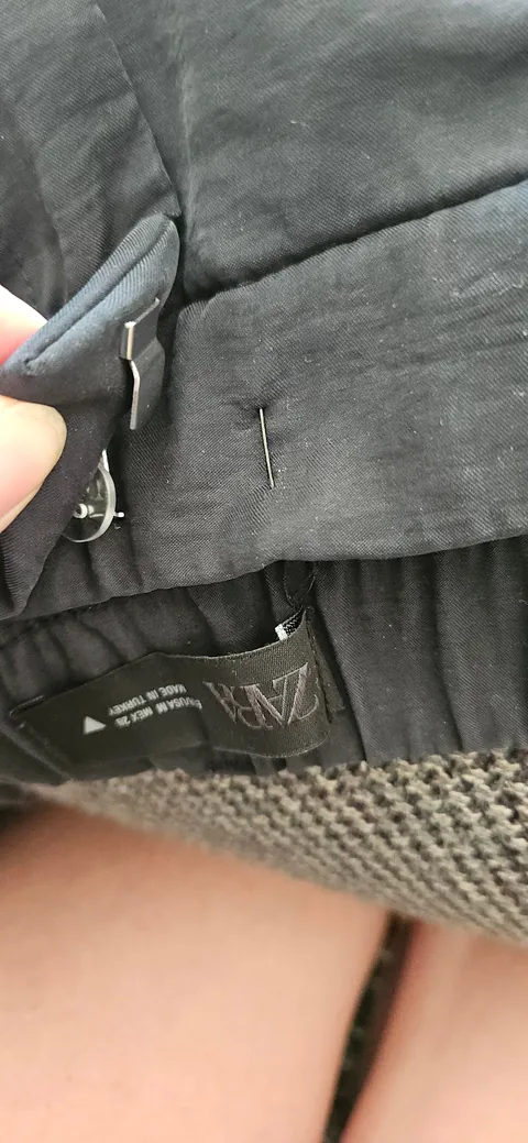 Use safety pins to quickly and cheaply reduce the waist size of pants with a hook and bar closure