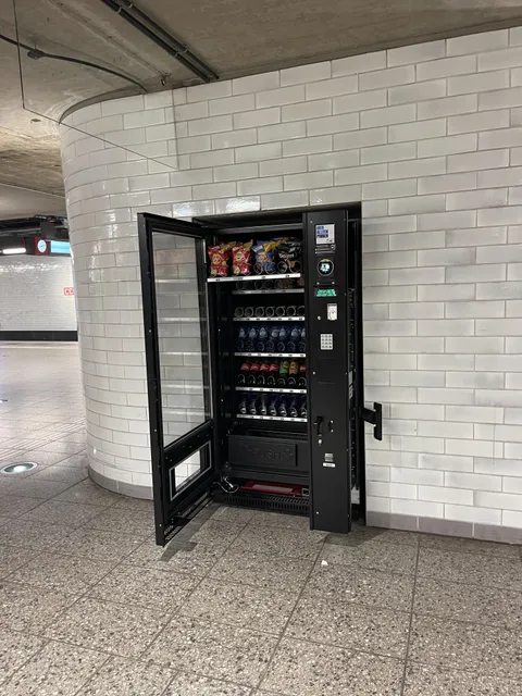 Open, unattended, vending machine on Amsterdam Central Station platform.
