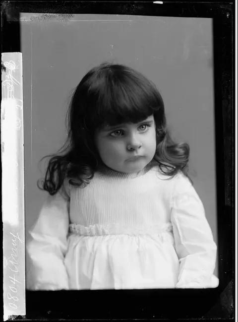Sharp Glass negative of a little girl, posing for the damera, 1890s.