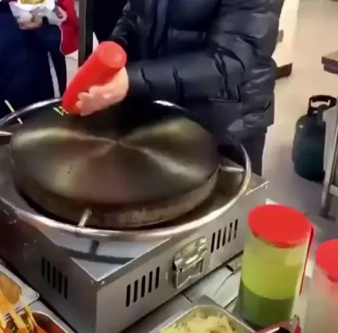 Making street food with a spinning grill