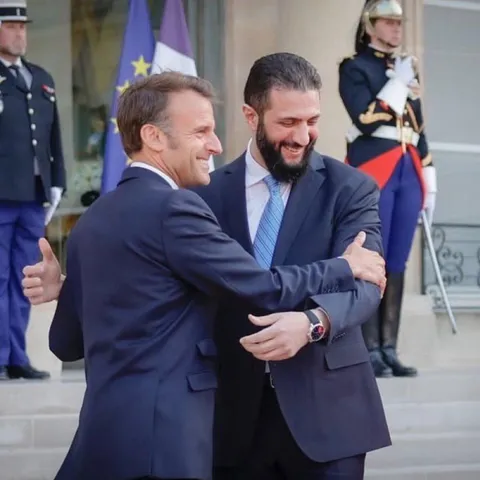 President of France embraces the president of Syria