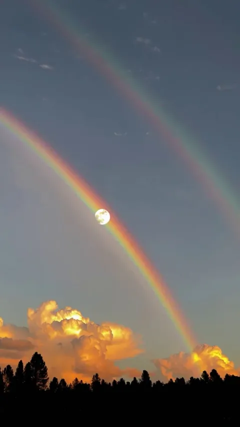 Moon perfectly suspended in the rainbow.Captured during a rare clear winter morning over Scotland.