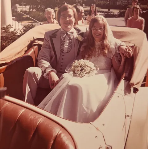 My parents leave their wedding in style in a vintage Rolls Royce.  1975.