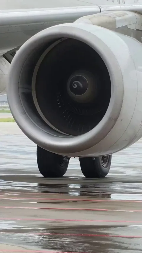 The aircraft engine is running, and consequently a swirling stream of water vapor has appeared near the ground.
