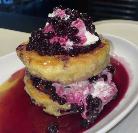 [I ate] fluffy buttermilk pancakes topped with maple syrup, whipped cream, and a wild blueberry compote from Mildred’s Kitchen in Toronto. 
