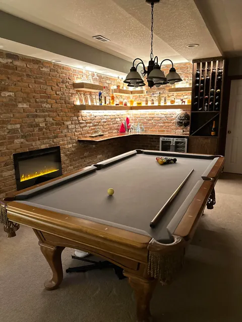 Remodeled my boring basement with reclaimed brick and structural wood