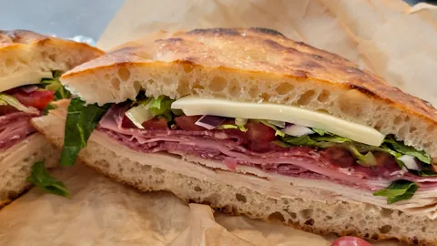 [homemade] Italian sandwich on sourdough focaccia with turkey, genoa salami, mortadella, coppa, lettuce, tomato, onion, provolone, and vinaigrette