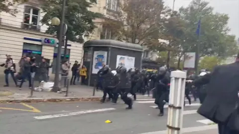 In France, police rush out to the people, expecting them to rush and create a stampede. No one moves and the police are forced to back down