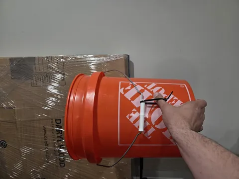 Put a zip tie on your bucks to dump them one handed