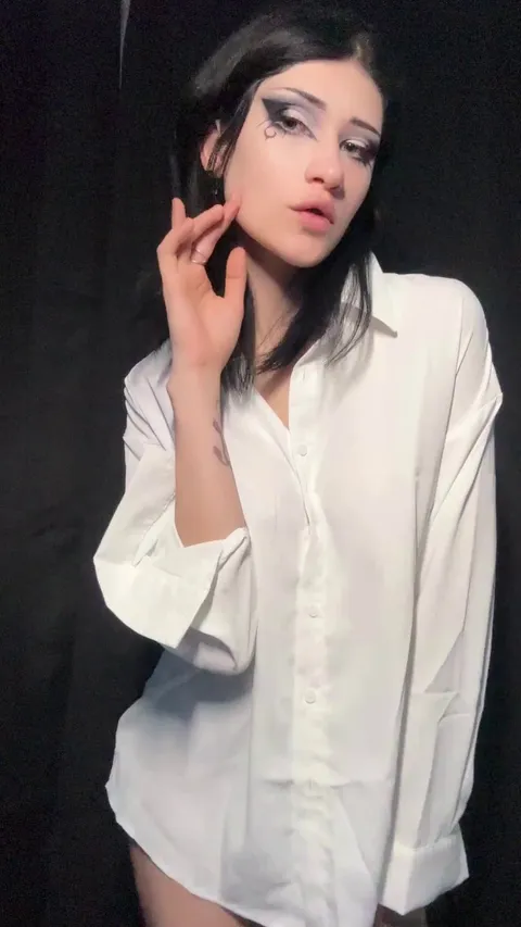 A gorgeous goth girl undresses for the camera