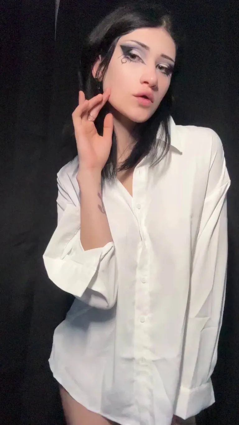 A gorgeous goth girl undresses for the camera