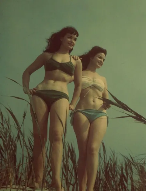 ‘Queen of Pinups’ Bettie Page, and her sister Goldie. Photograph hand-colored by Goldie, 1950s