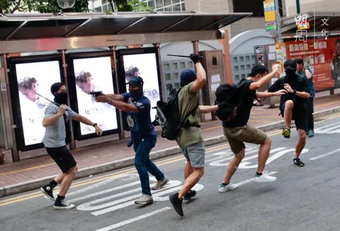Hong Kong Police pointed gun towards the crowd and beat citizens with batons after their disguise as protestors were blown