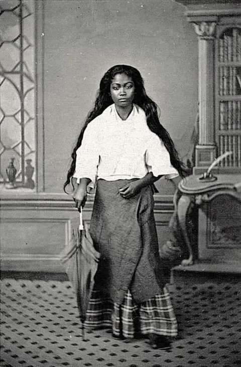 A young woman with a umbrella 1870s Philippines