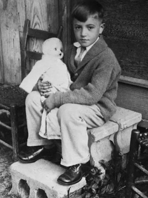 Carl Newton Mahan plays with a doll during a court hearing after he shot and killed another boy during a fight. At age six, Mahan became the youngest person to ever be tried for murder in American history, Kentucky, 1929