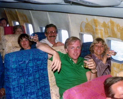 My parents, the couple in the front, on their flight home after going on a Mexican cruise in March, 1977. The couple behind them were friends of theirs that also went on the cruise.