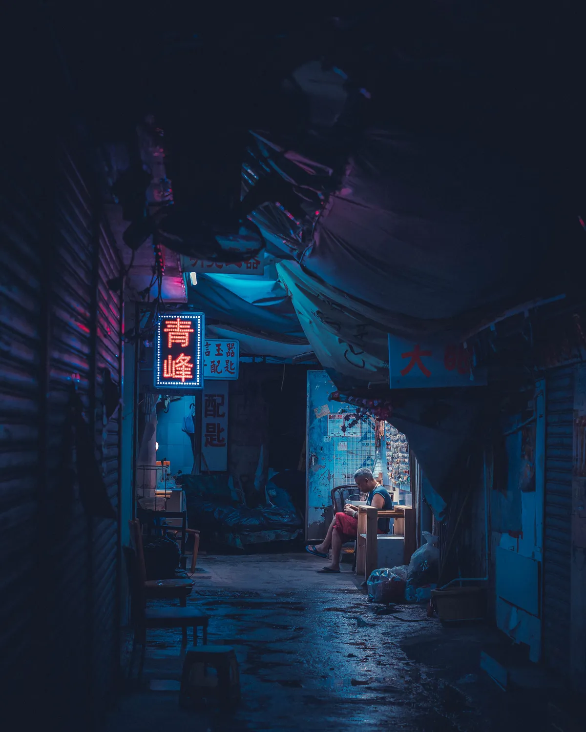 ITAP of a man in an alley on a rainy night