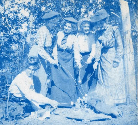 An unnamed young woman recorded her senior year at Asheville Female College in a photo album, Asheville, North Carolina, 1902. It includes a dorm room, group shots of friends, playing in snow, a visit to the mountains, their final midnight party before graduation, and graduation day itself.