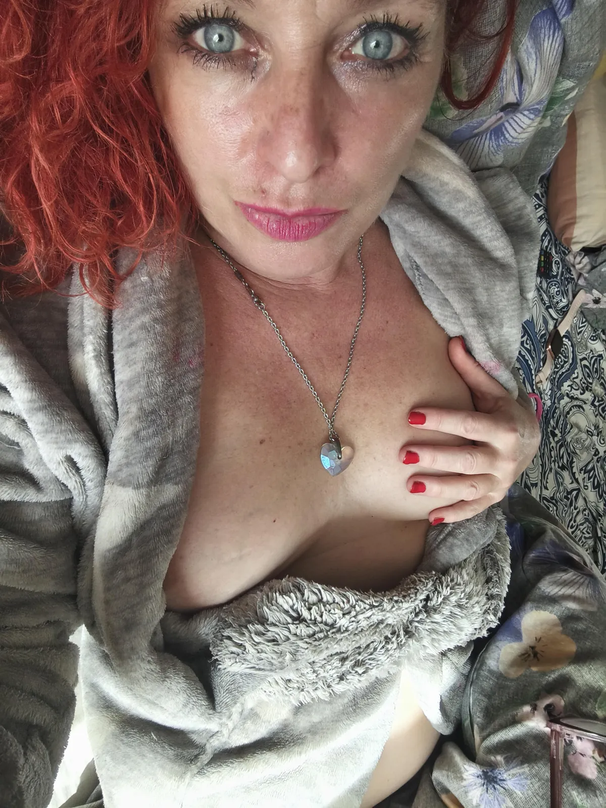 Fiery redhead showing off just a little tease... do you want me to open this robe wider?