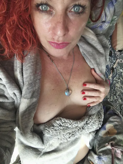 Fiery redhead showing off just a little tease... do you want me to open this robe wider?