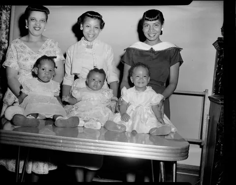 Mothers showing off their little baby girls as they compete in a little contest. May 1957