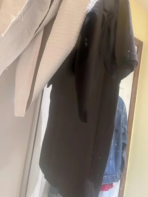 Hang a black t shirt on a glass shower door to make a reflective mirror to shave in the shower