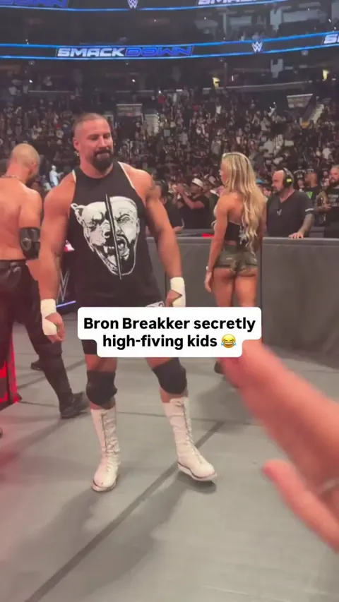 Bad Guy professional wrestler secretly giving high fives to kids to avoid breaking character