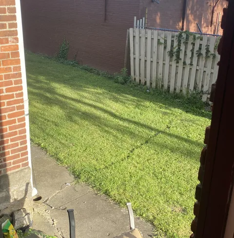 Crack in the pavement extends into the yard