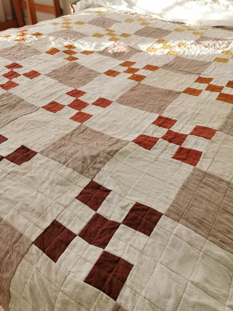 I taught myself to sew to make a cozy fall quilt for my bed. 90% thrifted fabric