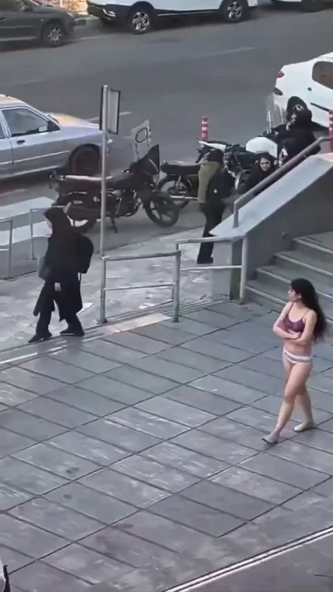 In Iran, a woman who was accosted by the “morality police” for not wearing hijab removes her clothing &amp; roams the streets in defiance. She has since been arrested by IRGC forces and forcibly disappeared.