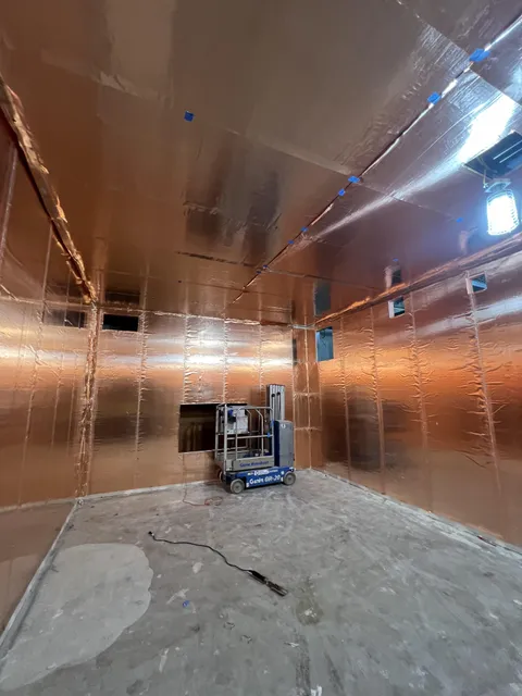 An MRI room under construction, coated with copper wallpaper