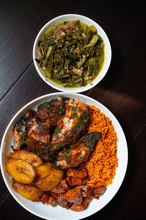 [homemade] smoked jerk chicken, jollof rice, collard greens, plantains and candied yams. 