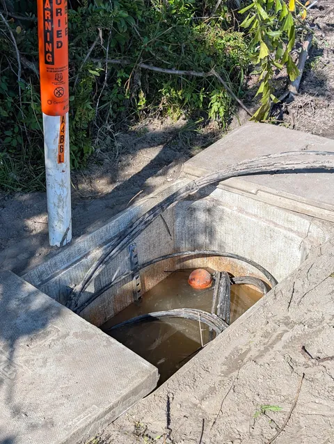 Internet cables running into a watery enclosure.