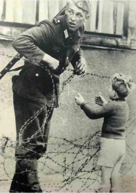 An East German soldier, against orders, let a boy cross the border to his family, 1961