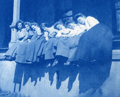 An unnamed young woman recorded her senior year at Asheville Female College in a photo album, Asheville, North Carolina, 1902. It includes a dorm room, group shots of friends, playing in snow, a visit to the mountains, their final midnight party before graduation, and graduation day itself.