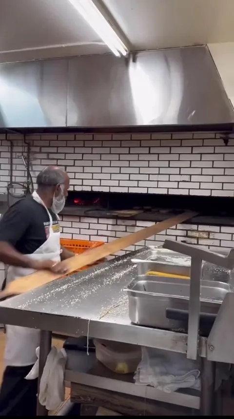 Guy gets a lot of bagels out of the oven at once