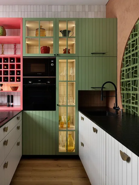 Eclectic kitchen featuring sage green and pink cabinetry with a terracotta feature wall, Barcelona, Spain [800x1067]