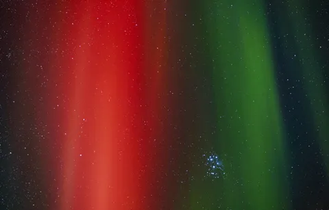 Pleiades shot through the Aurora.
