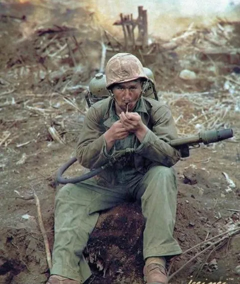 My great uncle Willie with his flamethrower and a pipe, Iwo Jima 1945.